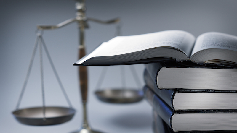 Scales of justice with a stack of books.